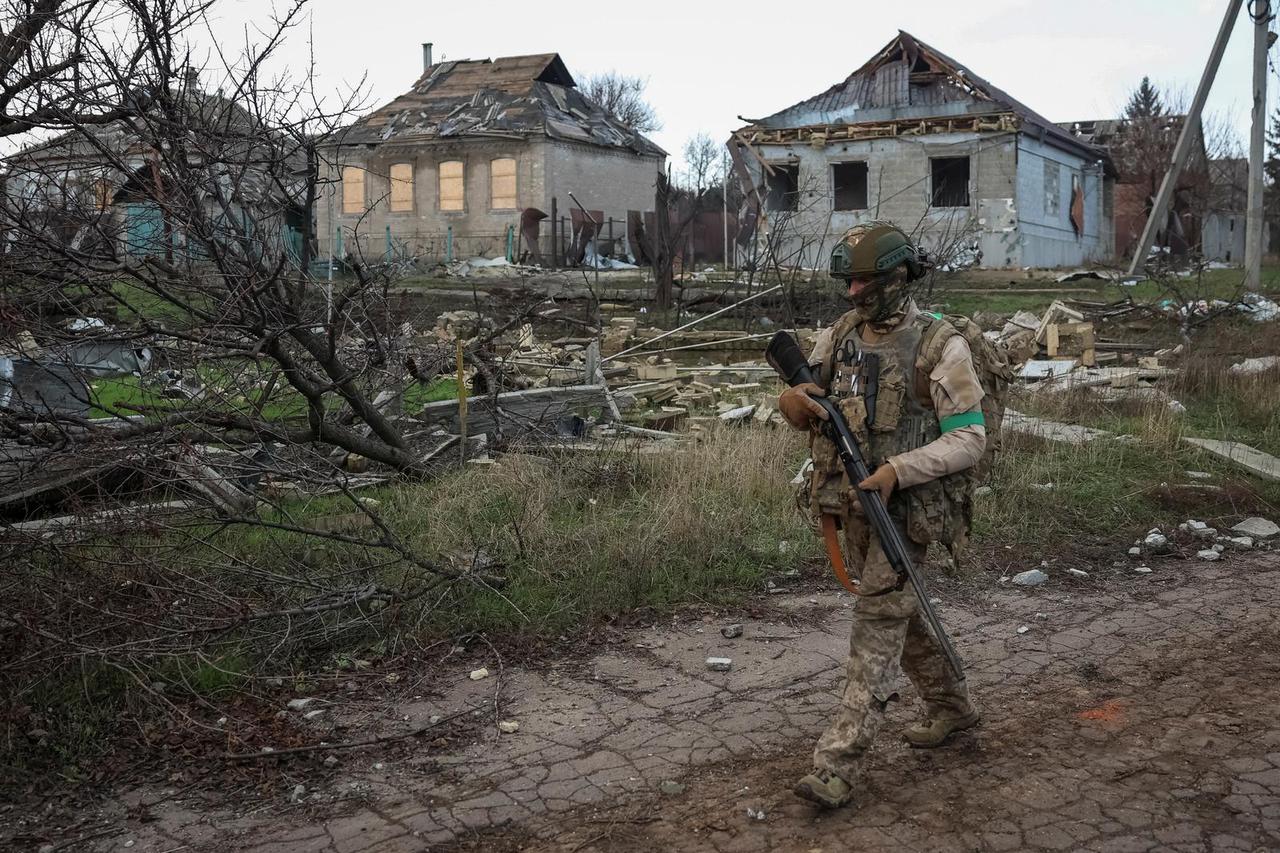 Ukrainian serviceman walks near buildings damaged by Russian military strike in the frontline town of Kostiantynivka