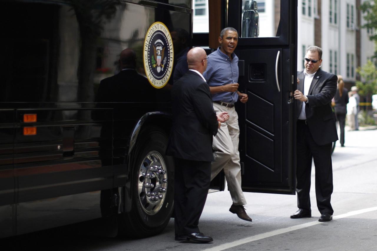 'U.S. President Barack Obama steps off his bus at Magnolia's Deli and Cafe in Rochester, New York, August 22, 2013. Obama is travelling through New York state and Pennsylvania on a two-day bus tour t