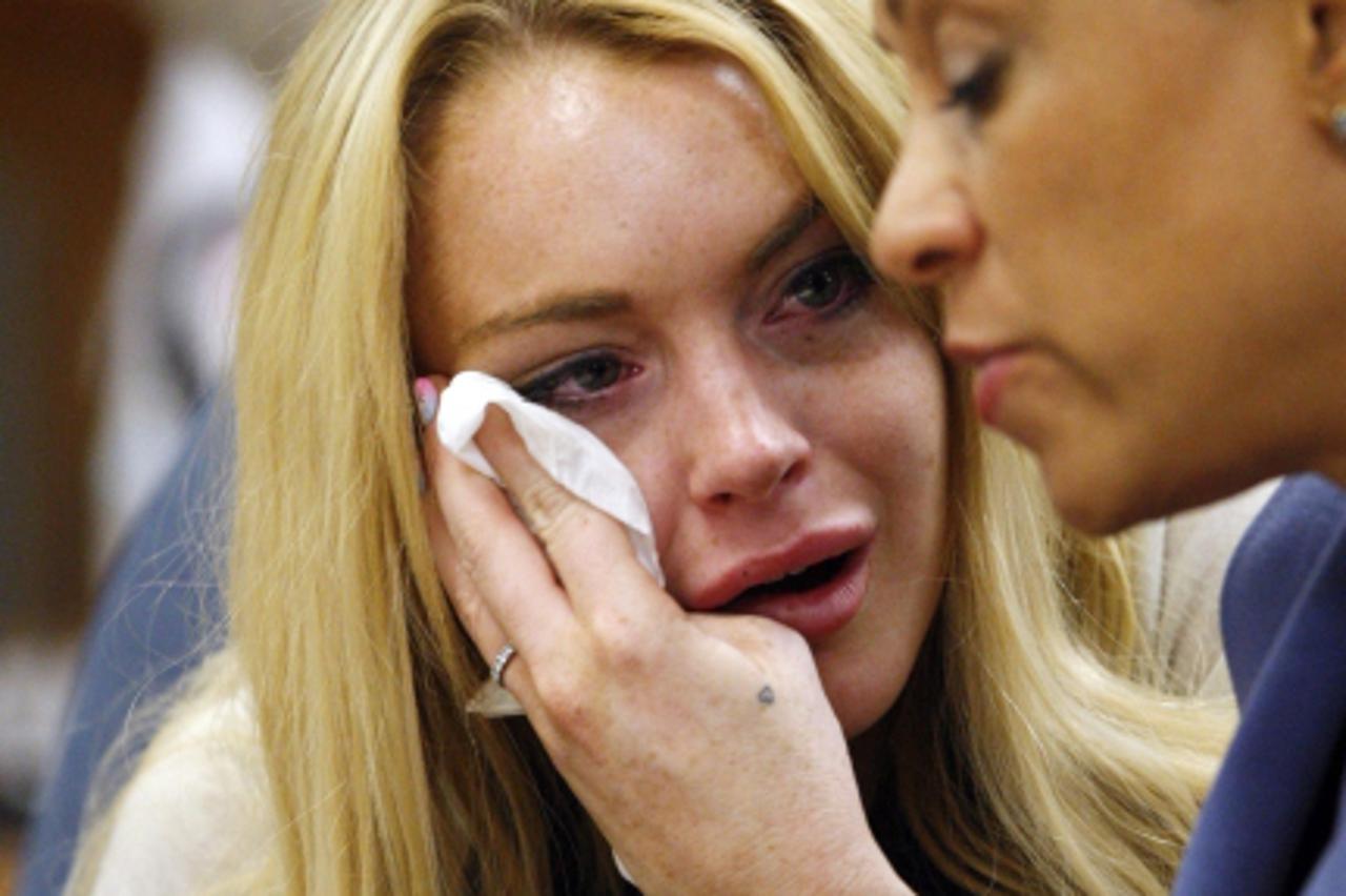 'WORLD RIGHTS NO USA, FRANCE, AUSTRALIA.   Lindsay Lohan wipes tears while looking at her attorney Shawn Chapman Holley after the sentencing by Superior Court Judge Marsha Revel during a status hearin