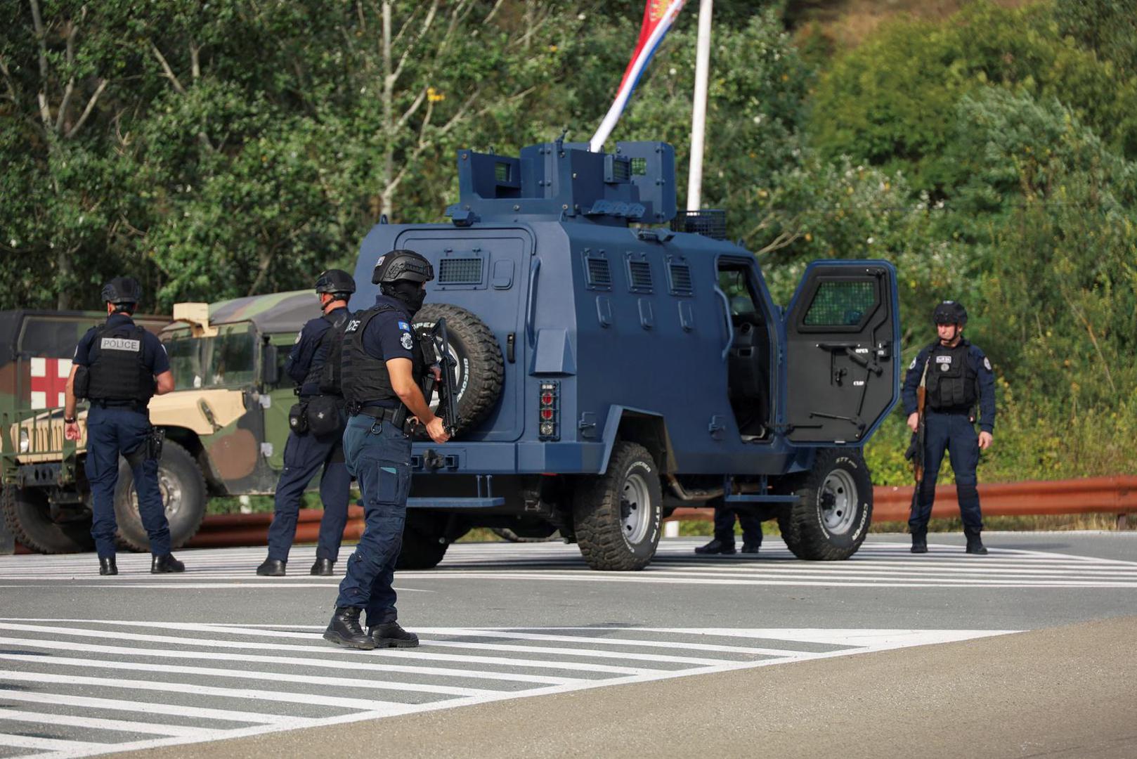 People work as Kosovo police and U.S. and EU troops stand by after one police officer was killed, another hurt in Kosovo gunfire, in Josevik, Kosovo September 24, 2023. REUTERS/Fatos Bytyci Photo: FATOS BYTYCI/REUTERS