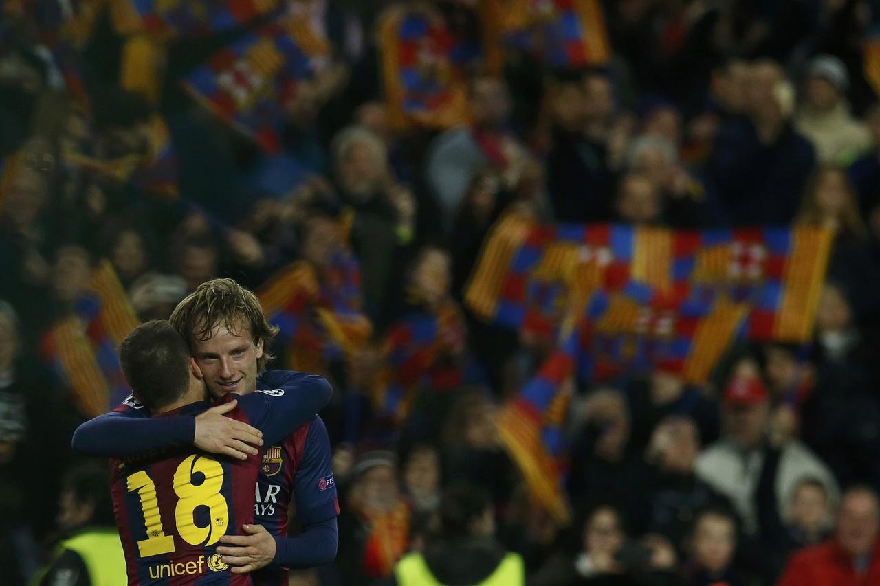 Barcelona's Ivan Rakitic (R) is congratulated by his team mate Jordi Alba after scoring a goal against Manchester City during their Champions League round of 16 second leg soccer match at Camp Nou stadium in Barcelona March 18, 2015.     REUTERS/Albert Ge
