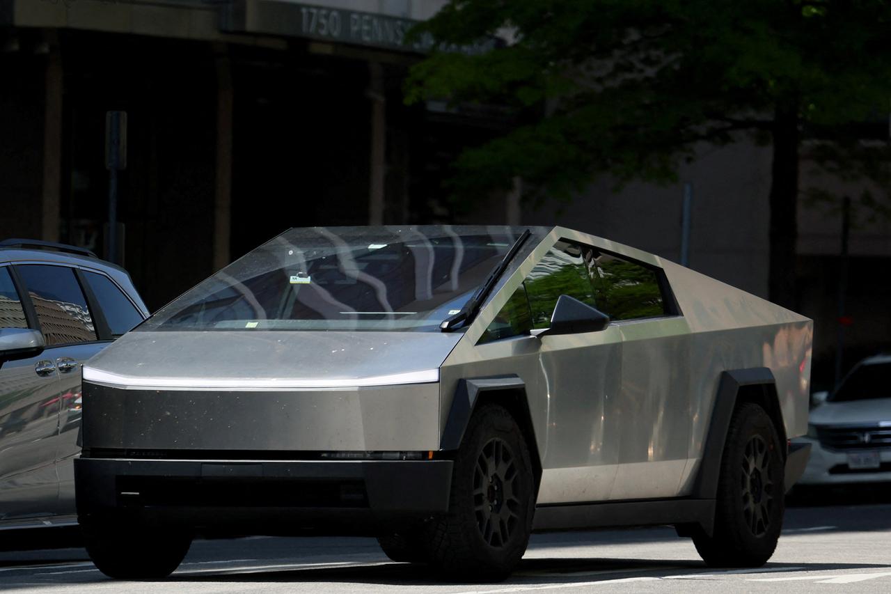 A Tesla Cybertruck is driven down Pennsylvania Ave near the White House in Washington