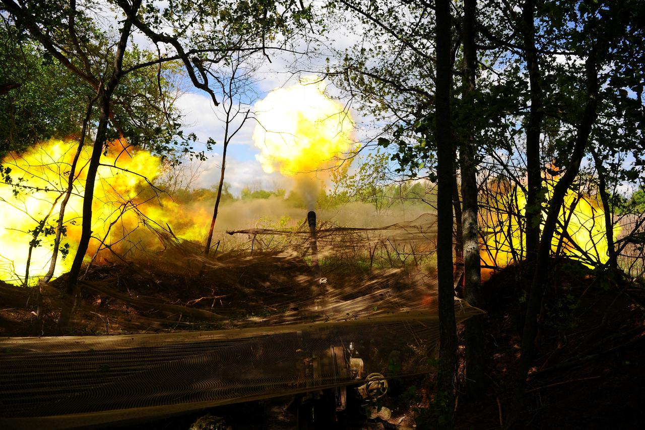 Ukrainian servicemen fire a self-propelled howitzer towards Russian troops at a frontline near the town of Chasiv Yar