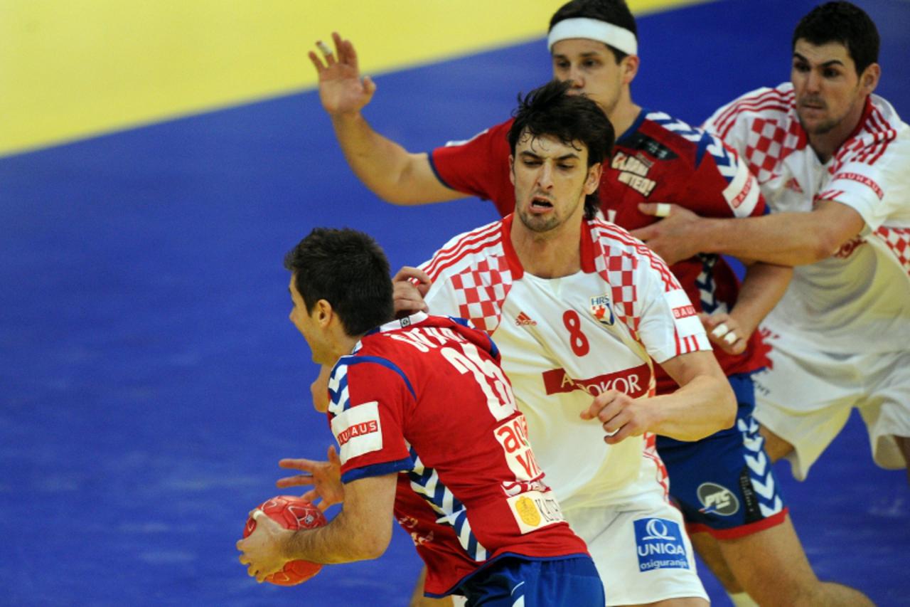 'Croatia\'s Marko Kopljar (2nd L) tries to stop Serbia\'s Dalibor Cutura during the men\'s EHF Euro 2012 Handball Championship semifinal match Serbia vs Croatia on January 27, 2012 at the Beogradska A