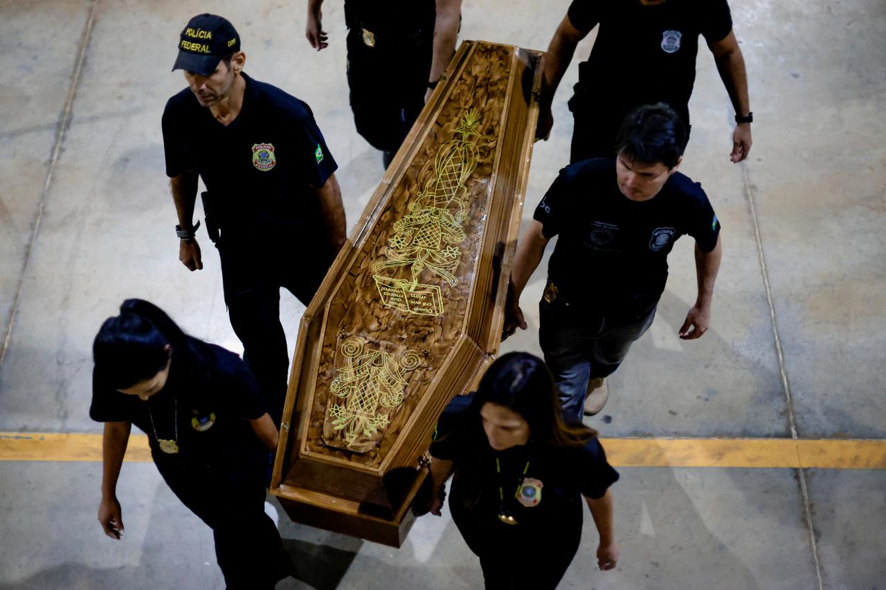 Federal Police officers carry a coffin containing human remains after a suspect confessed to killing British journalist Dom Phillips and Brazilian indigenous expert Bruno Pereira, in Brasilia