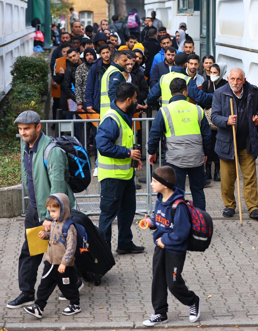 Migrants queue in a waiting area to be escorted to a registration office at the arrival centre for asylum seekers in Reinickendorf district, Berlin, Germany, October 6, 2023. REUTERS/Fabrizio Bensch Photo: Fabrizio Bensch/REUTERS