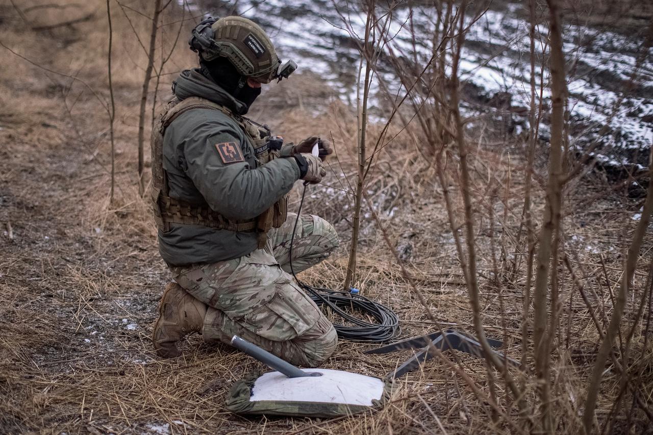 FILE PHOTO: A Ukrainian serviceman of 47th brigade prepares a Starlink satellite internet systems at his positions at a front line the town of Avdiivka