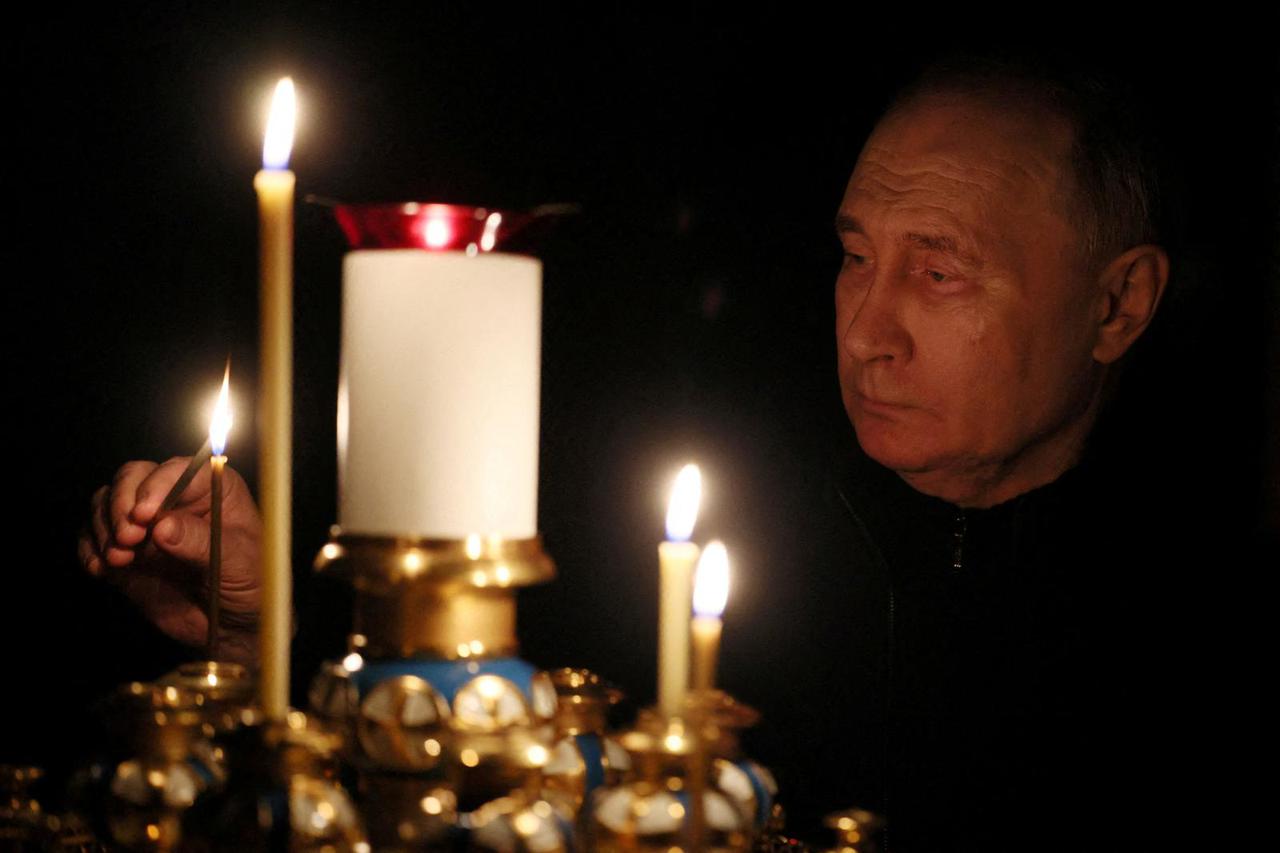 Russian President Putin lights a candle in memory of the victims of the Crocus City Hall attack, in Moscow Region