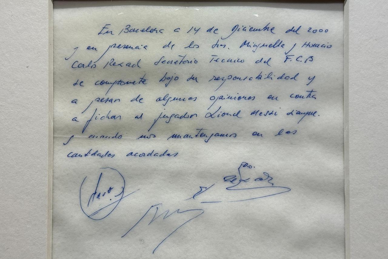Signed and framed napkin on which soccer club Barcelona promised to sign a 13-year-old Lionel Messi is displayed at the Bonhams auction house in London