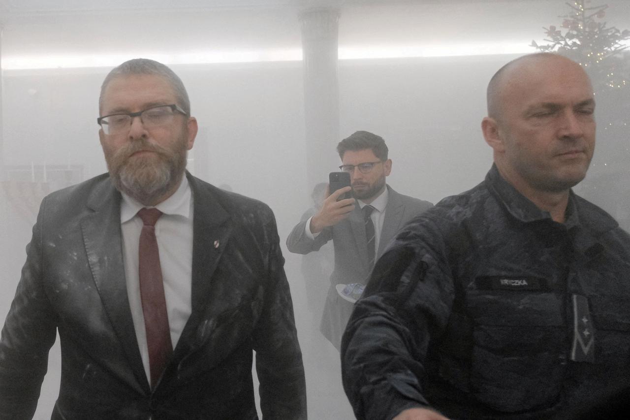 FILE PHOTO: Grzegorz Braun, far-right Polish lawmaker from Confederation party, walks after using a fire extinguisher to put out Hanukkah candles at the parliament in Warsaw