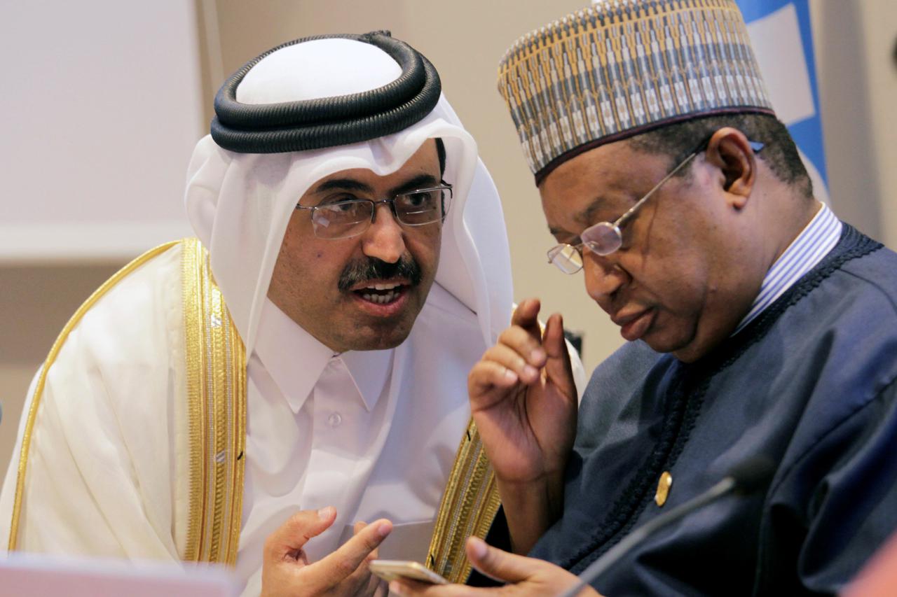 Organization of Petroleum Exporting Countries (OPEC) President, Qatar's Minister of Energy Mohammed bin Saleh al-Sada speaks with Secretary General of OPEC Mohammed Sanusi Barkindo (R), during a news conference after an informal meeting between members of
