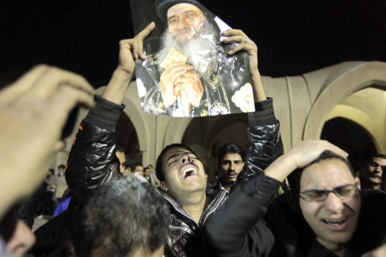 'Egyptian Christian Copts mourn the death of Pope Shenouda III, the 117th Pope of the Coptic Orthodox Church of Alexandria and Patriarch of the See of St. Mark Cathedral outside the main cathedral in 