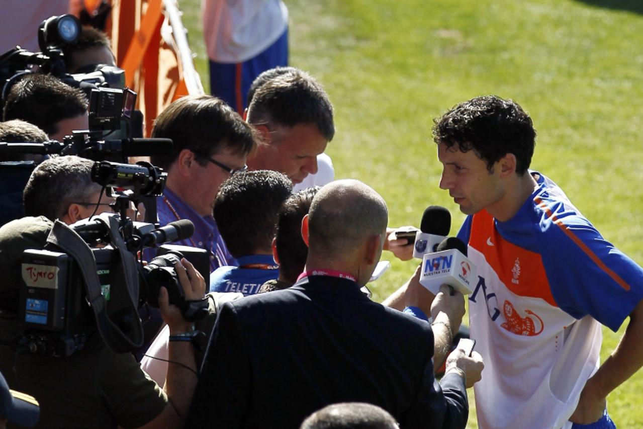 'Netherlands\' midfielder Mark van Bommel (R) answers questions of the press after a training session at the Wits University in Johannesburg, on June 7, 2010. The Dutch face Denmark, Japan and Cameroo