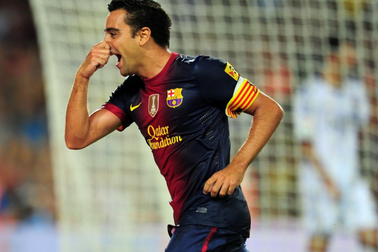 'Barcelona\'s midfielder Xavi Hernandez celebrates after scoring a goal during the first leg of the Spanish Supercup football match FC Barcelona vs Real Madrid CF on August 23, 2012 at the Camp Nou st