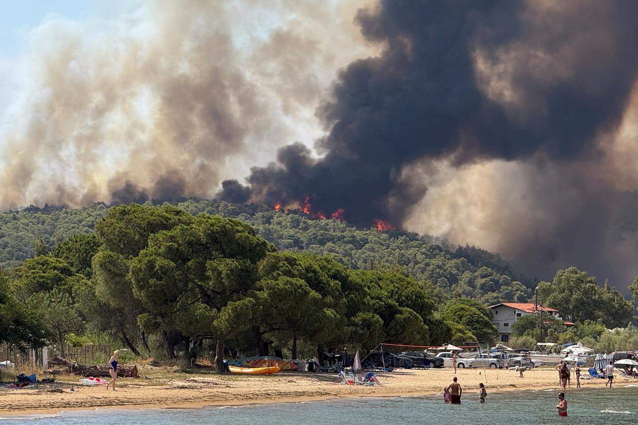 Wildfire burns in the village of Vourvourou