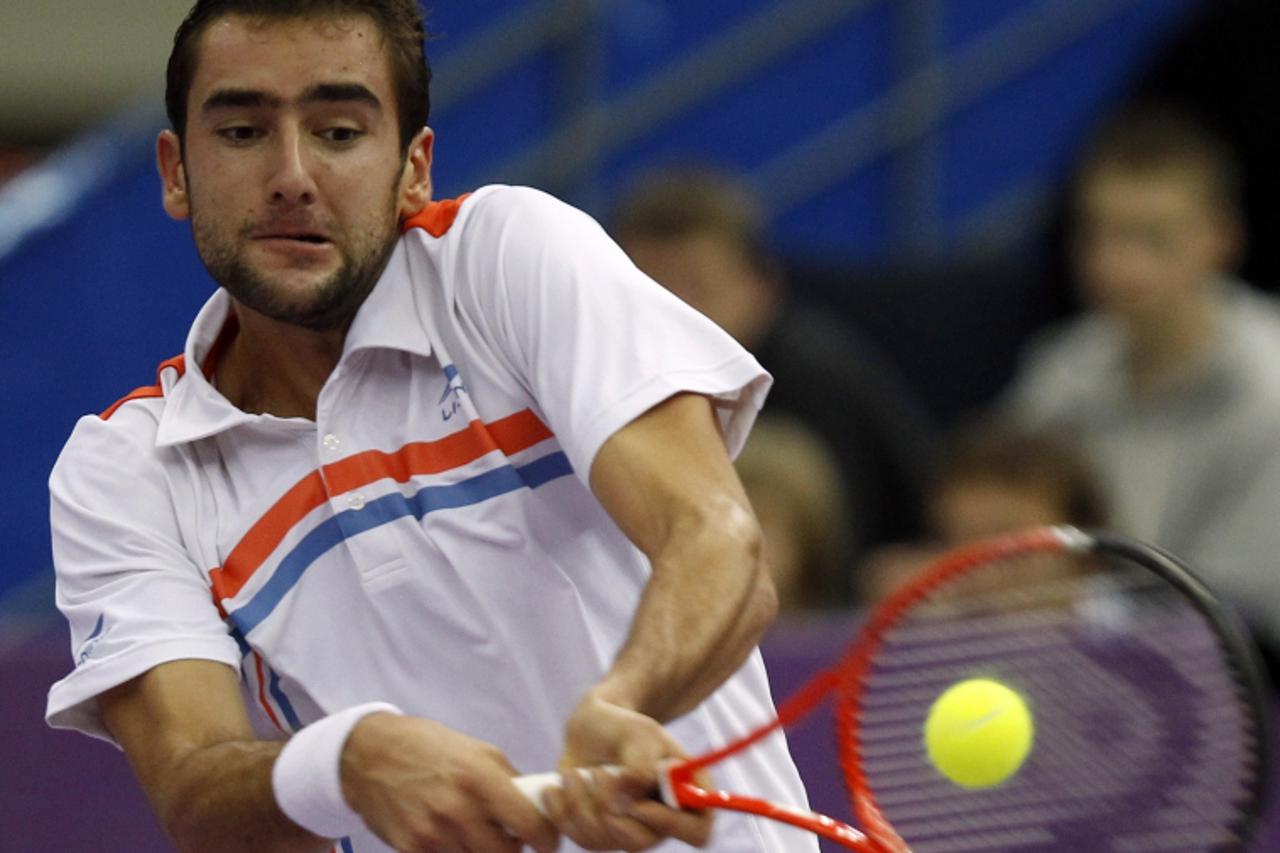 'Marin Cilic of Croatia returns the ball to Mikhail Youzhny of Russia during their ATP St. Petersburg Open tennis tournament semifinal match in St. Petersburg October 29, 2011.  REUTERS/Alexander Demi