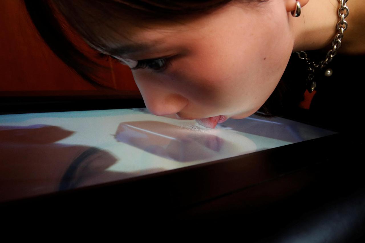 Demonstration of Taste the TV (TTTV), a prototype lickable TV screen that can imitate the flavours of various foods in Tokyo