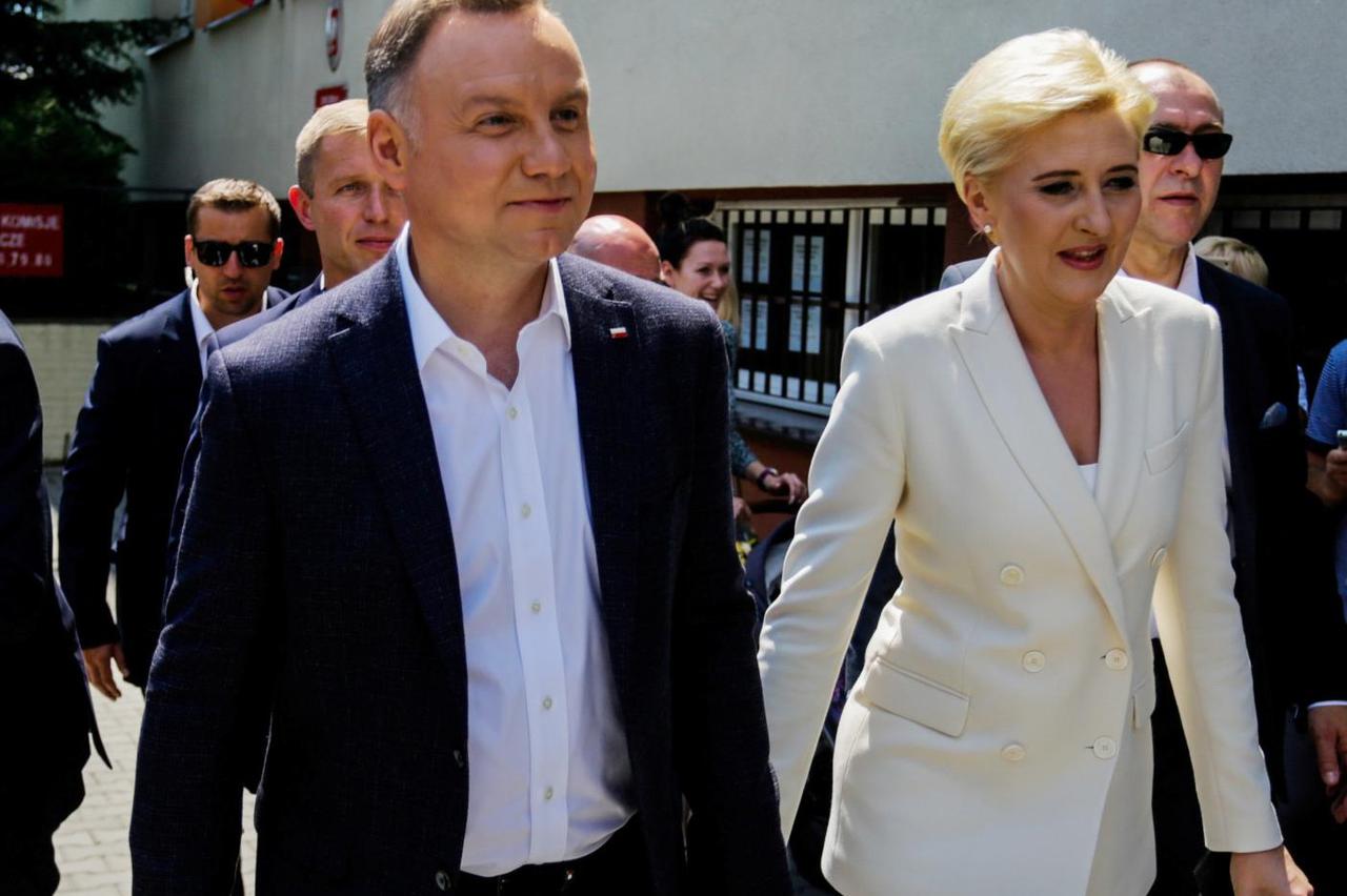 Polish President Andrzej Duda and his wife Agata Kornhauser-Duda leave a polling station during the presidential election in Krakow