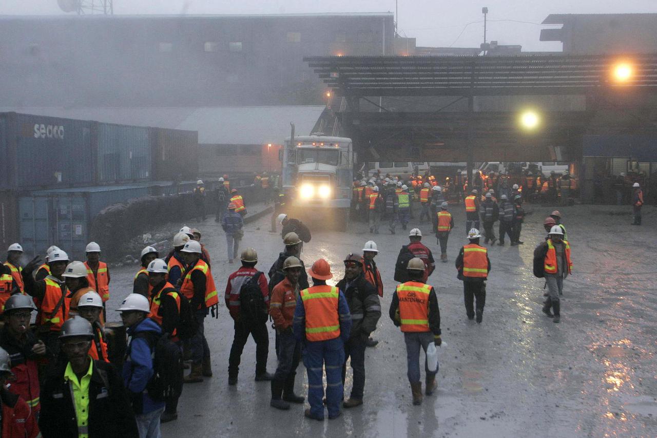 FILE PHOTO: Freeport workers gather around security gate at at Grasberg mine area in Tembagapura