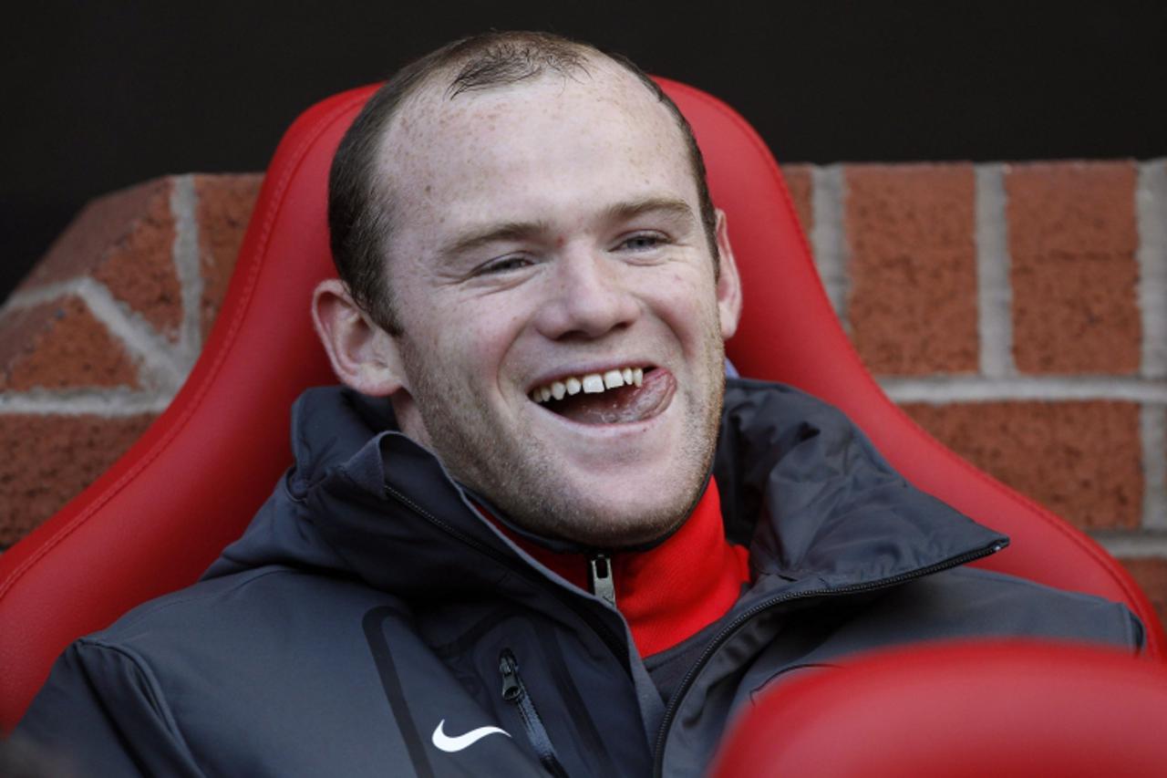 'Manchester United\'s Wayne Rooney smiles as he takes his seat on the bench before their English Premier League soccer match against West Bromwich Albion at Old Trafford in Manchester, northern Englan