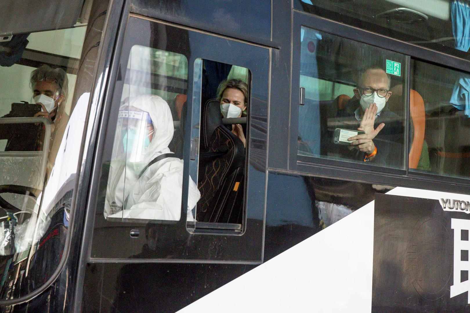 Members of the WHO team tasked with investigating the origins of the coronavirus disease (COVID-19) pandemic in Wuhan Members of the World Health Organisation (WHO) team tasked with investigating the origins of the coronavirus disease (COVID-19) pandemic sit on a bus while leaving Wuhan Tianhe International Airport in Wuhan, Hubei province, China January 14, 2021. REUTERS/Thomas Peter THOMAS PETER