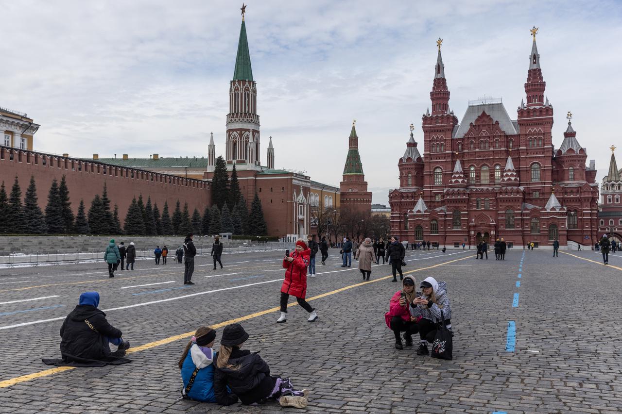 People take pictures in the Red Square during Spring weather in Moscow