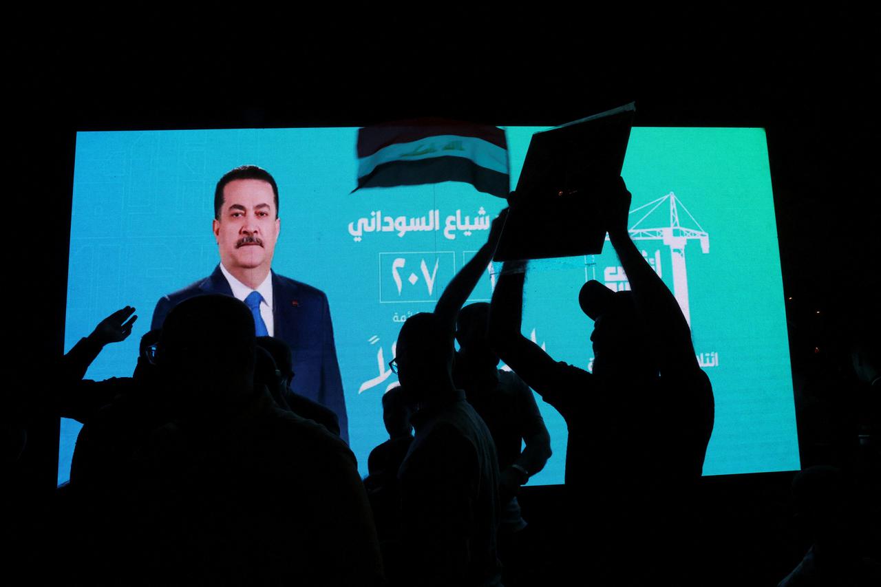 Supporters of the Reconstruction and Development Coalition celebrate after preliminary election results were announced in Baghdad