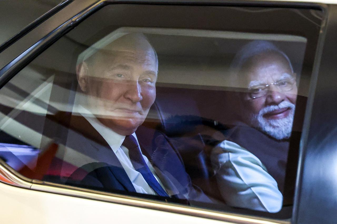 Russian President Vladimir Putin and Indian Prime Minister Narendra Modi arrive for an informal dinner in New Delhi