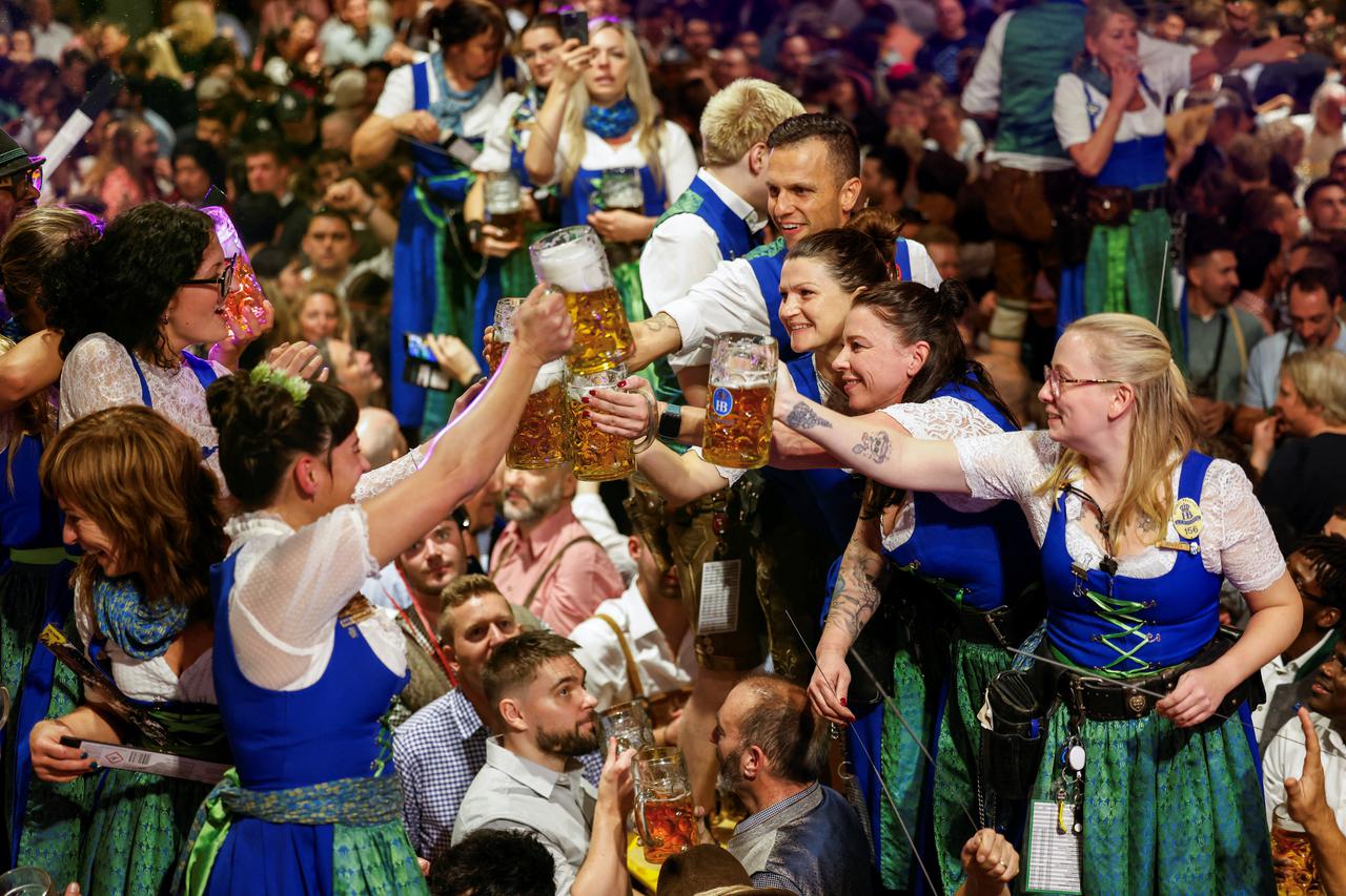 Oktoberfest waitresses toast with beer while they celebrate the end of the 189th Oktoberfest in Munich