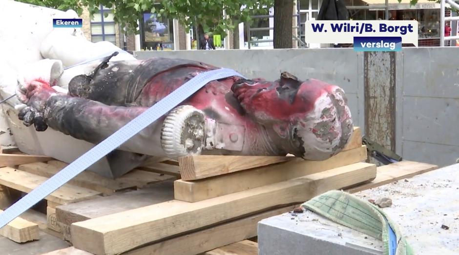A damaged statue of former Belgian King Leopold II is seen being removed for possible renovation in Ekeren