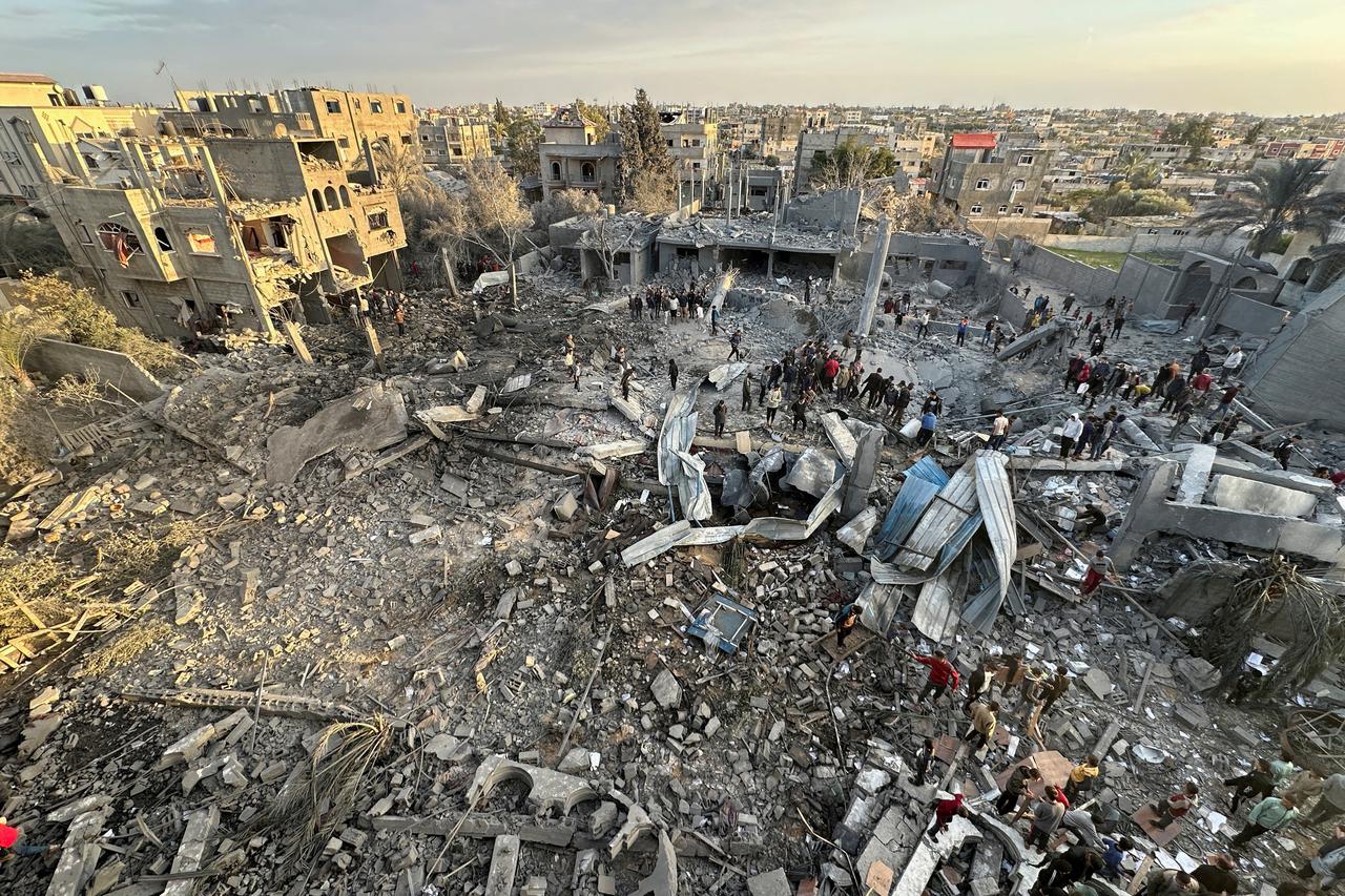 Palestinians inspect the site of an Israeli strike on a mosque, in Rafah