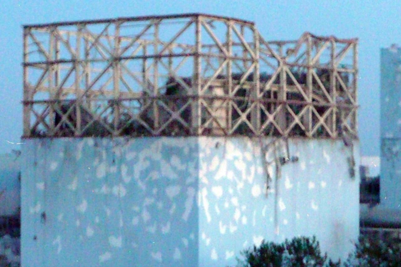 'The damaged roof of reactor number No. 1 at the Fukushima Daiichi nuclear plant after an explosion that blew off the upper part of the structure is seen in this handout photo released by Tokyo Electr