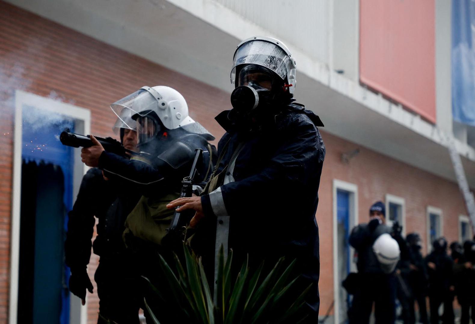A police officer fires tear gas as protesters attack the headquarters of the Democratic Party in Tirana, Albania, January 8, 2022. REUTERS/Florion Goga Photo: Florion Goga/REUTERS