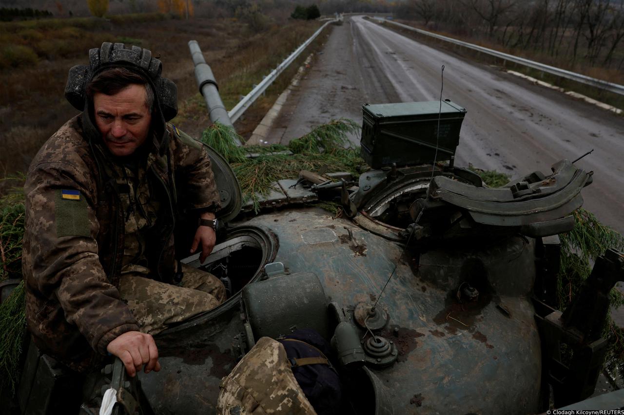 Ukrainian soldiers fires a round from a former Russian tank, in Bakhmut