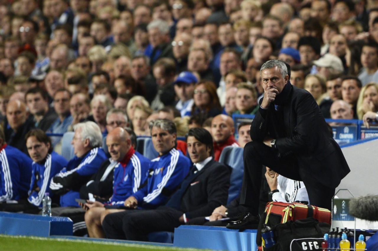 'Chelsea\'s manager Jose Mourinho watches his team during their Champions League soccer match against Basel at Stamford Bridge in London September 18, 2013.    REUTERS/Dylan Martinez (BRITAIN - Tags: 