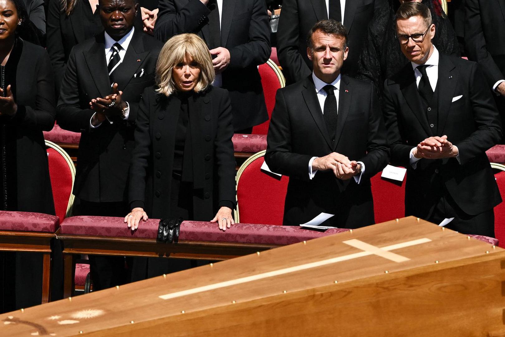 France's President Emmanuel Macron and his wife Brigitte Macron watch as the coffin of Pope Francis is carried by pallbearers during his funeral Mass in St. Peter's Square at the Vatican, April 26, 2025. REUTERS/Dylan Martinez Photo: Dylan Martinez/REUTERS