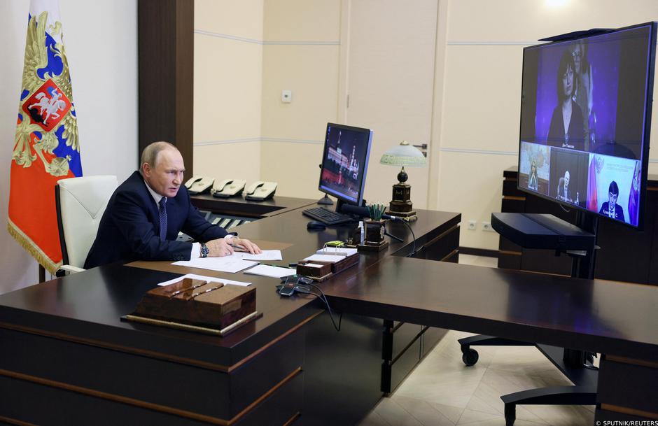 Russian President Vladimir Putin takes part in a video conference with a group of award-winning teachers