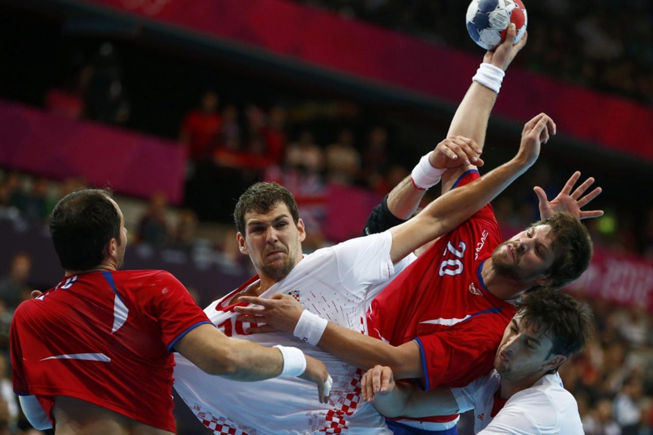 'Croatia's Jakov Gojun (C) blocks Serbia's Momir Rnic in their men's handball Preliminaries Group B match at the Copper Box venue during the London 2012 Olympic Games July 31, 2012. REUTERS/Marko D