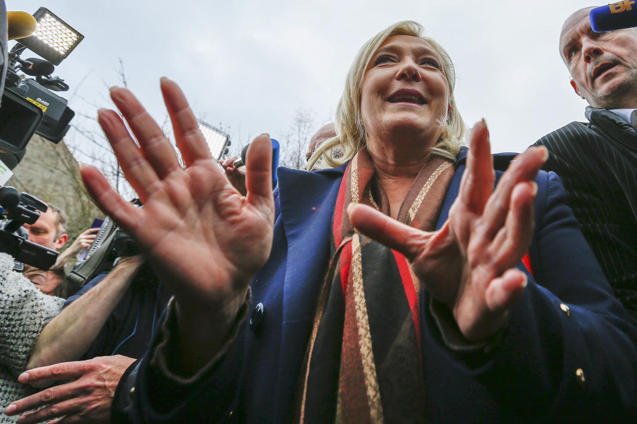 Marine Le Pen, French National Front political party leader and candidate for the National Front in the Nord-Pas-de-Calais-Picardie region, leaves the polling station after casting her ballot in the second-round regional elections in Henin-Beaumont, Franc