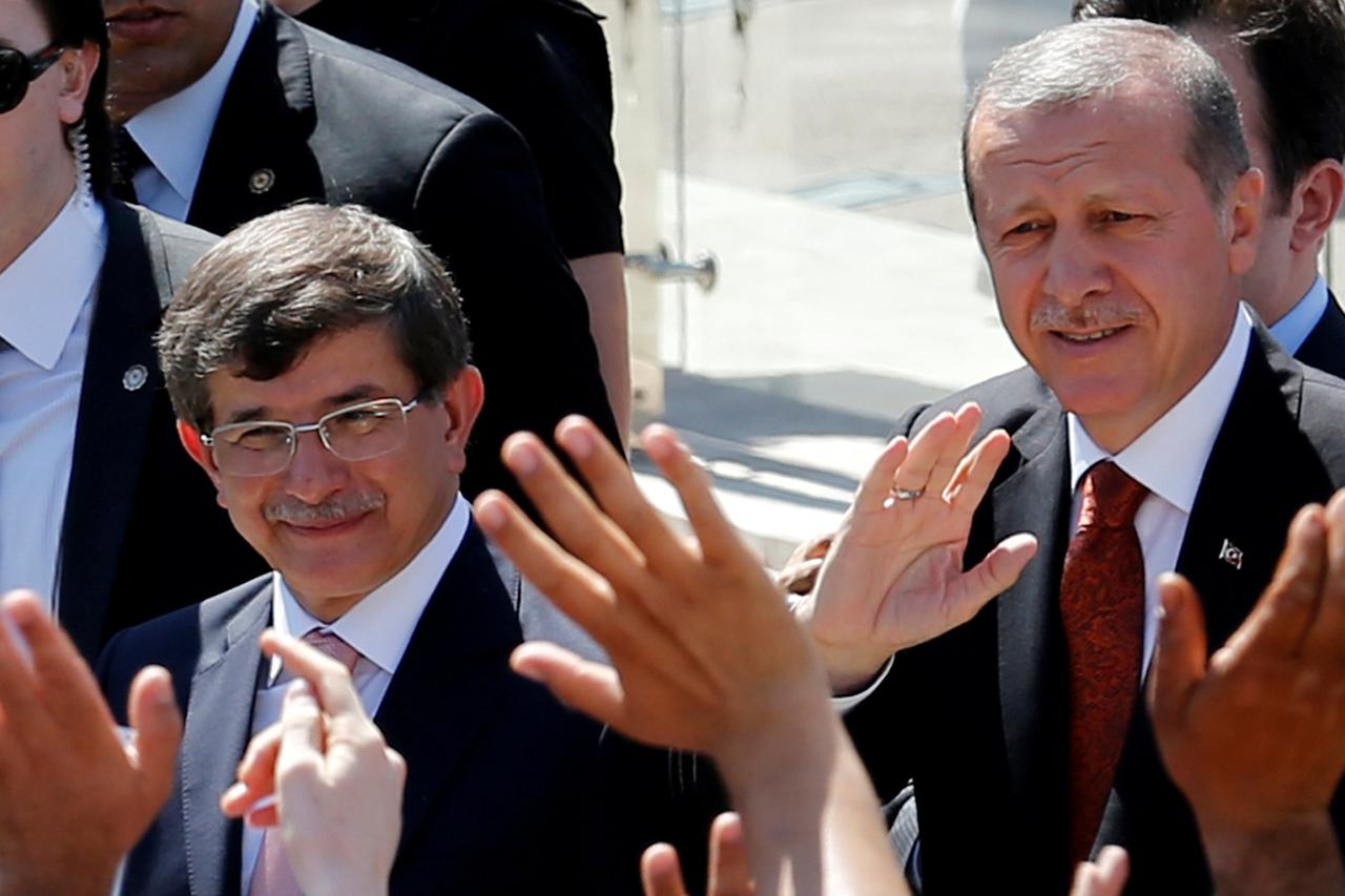 Turkey's then-Prime Minister Tayyip Erdogan (R) and then-Foreign Minister Ahmet Davutoglu greet their supporters as they leave Friday prayers in Ankara, Turkey, August 22, 2014. REUTERS/Umit Bektas/File Photo