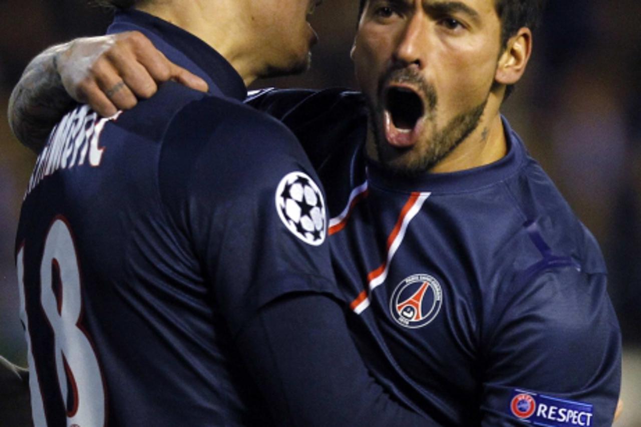 'Paris Saint Germain's Ezequiel Lavezzi (R) celebrates with teammate Zlatan Ibrahimovic after scoring a goal against Valencia during their Champions League soccer match at Mestalla stadium in Valenci