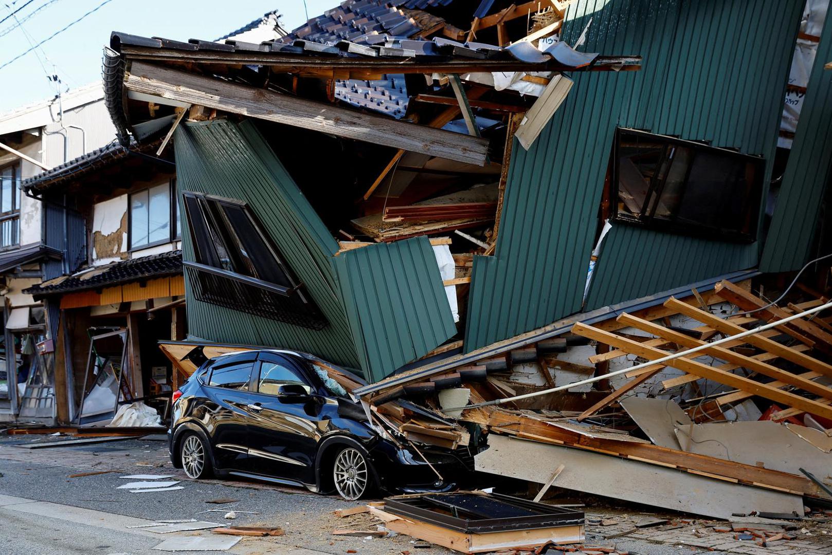 A damaged car stands near a collapsed house, following an earthquake, in Nanao, Ishikawa prefecture, Japan January 2, 2024, REUTERS/Kim Kyung-Hoon     TPX IMAGES OF THE DAY Photo: KIM KYUNG-HOON/REUTERS