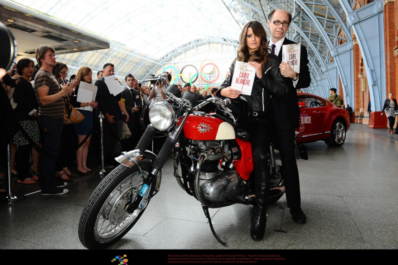 'Thriller writer Jeffery Deaver arrives with a Bond girl to promote his new James Bond novel \'Carte Blanche\' during a photocall at St. Pancras station in London. Photo: Press Association/Pixsell'