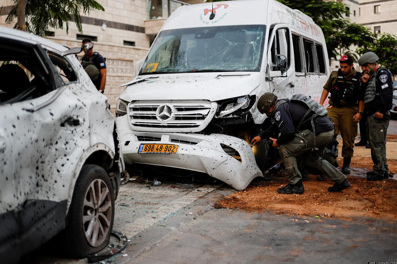 Israeli police inspect a vehicle that was damaged following rockets attack from Gaza towards Israel in Ashkelon