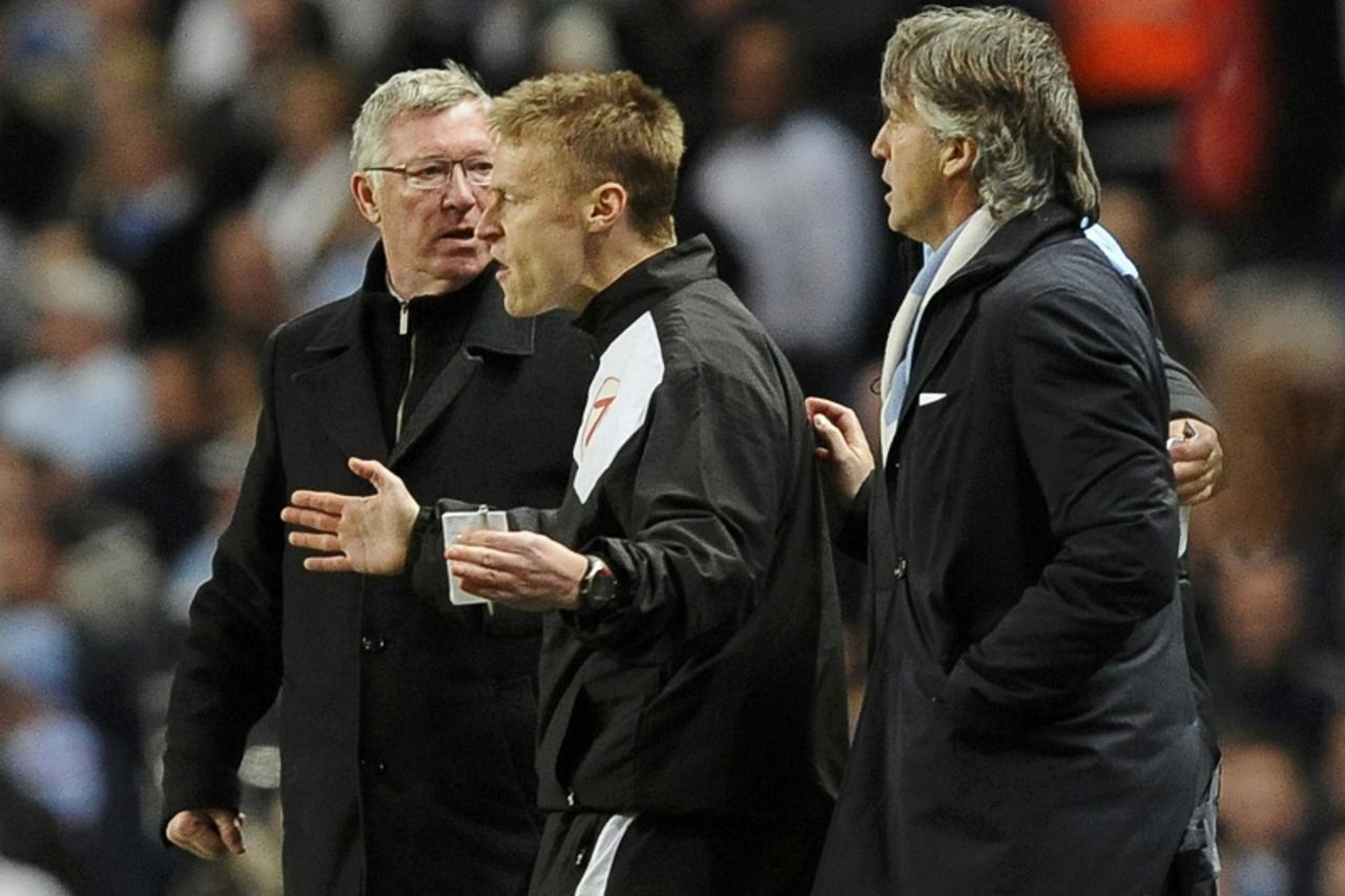 \'Manchester City manager Roberto Mancini (R) and Manchester United manager Alex Ferguson (L) are separated after arguing during their English Premier League soccer match at the Etihad stadium in Manc