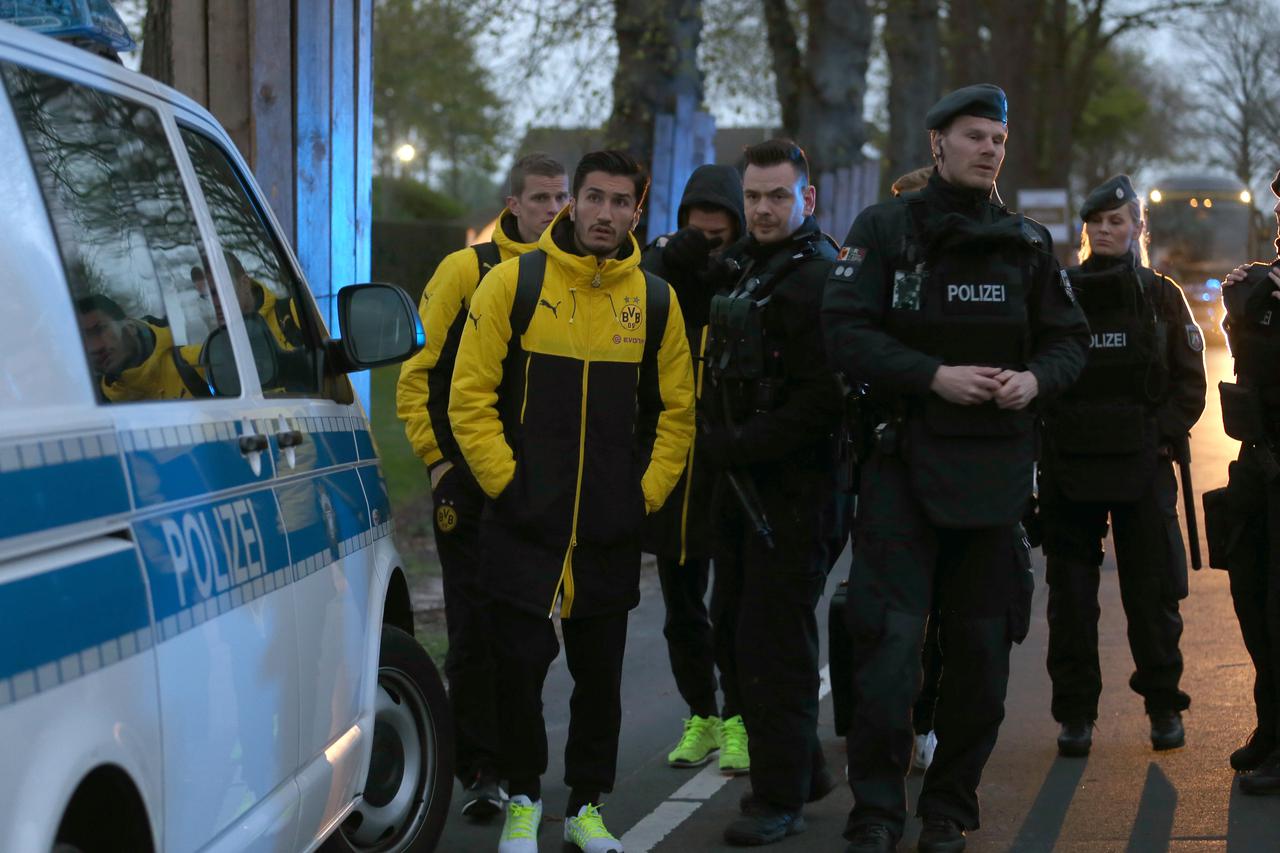 Borussia Dortmund players in a street in Dortmund, Germany, 11 April 2017. Three explosive devices detonated near the team bus shortly after its departure from the hotel in which the team was staying according to a statement by police in the city. The bus