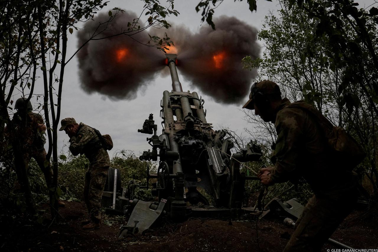 FILE PHOTO: Ukrainian service members fire a shell from a M777 Howitzer at a front line