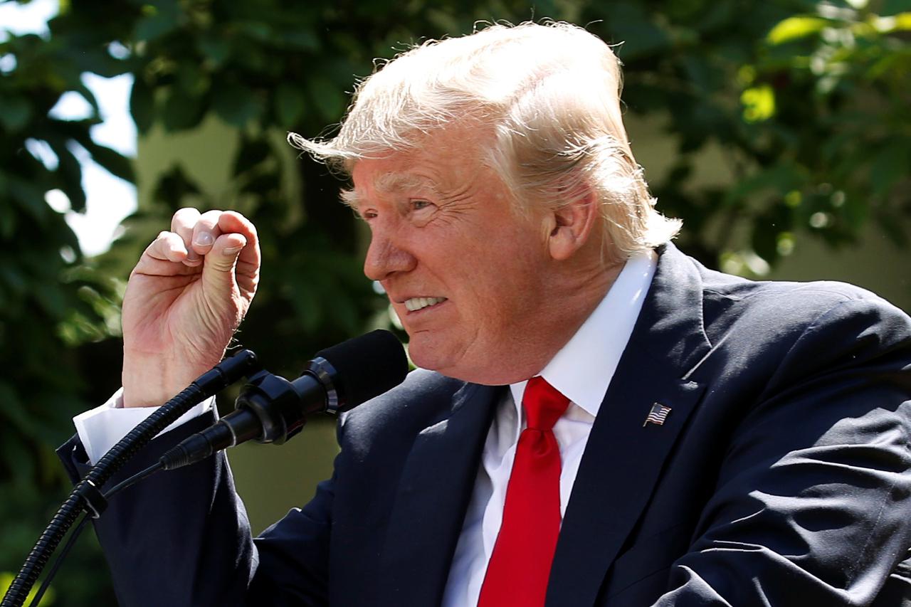 FILE PHOTO: U.S. President Trump refers to temperature change as he announces decision to withdraw from Paris Climate Agreement at White House in Washington