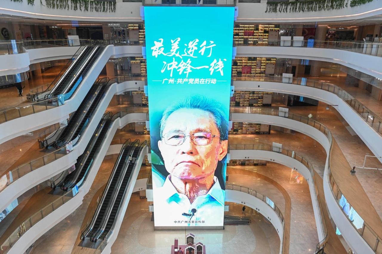 Screen showing an image of Zhong Nanshan is seen inside a shopping mall following the extended Lunar New Year holiday in the central business district of Guangzhou
