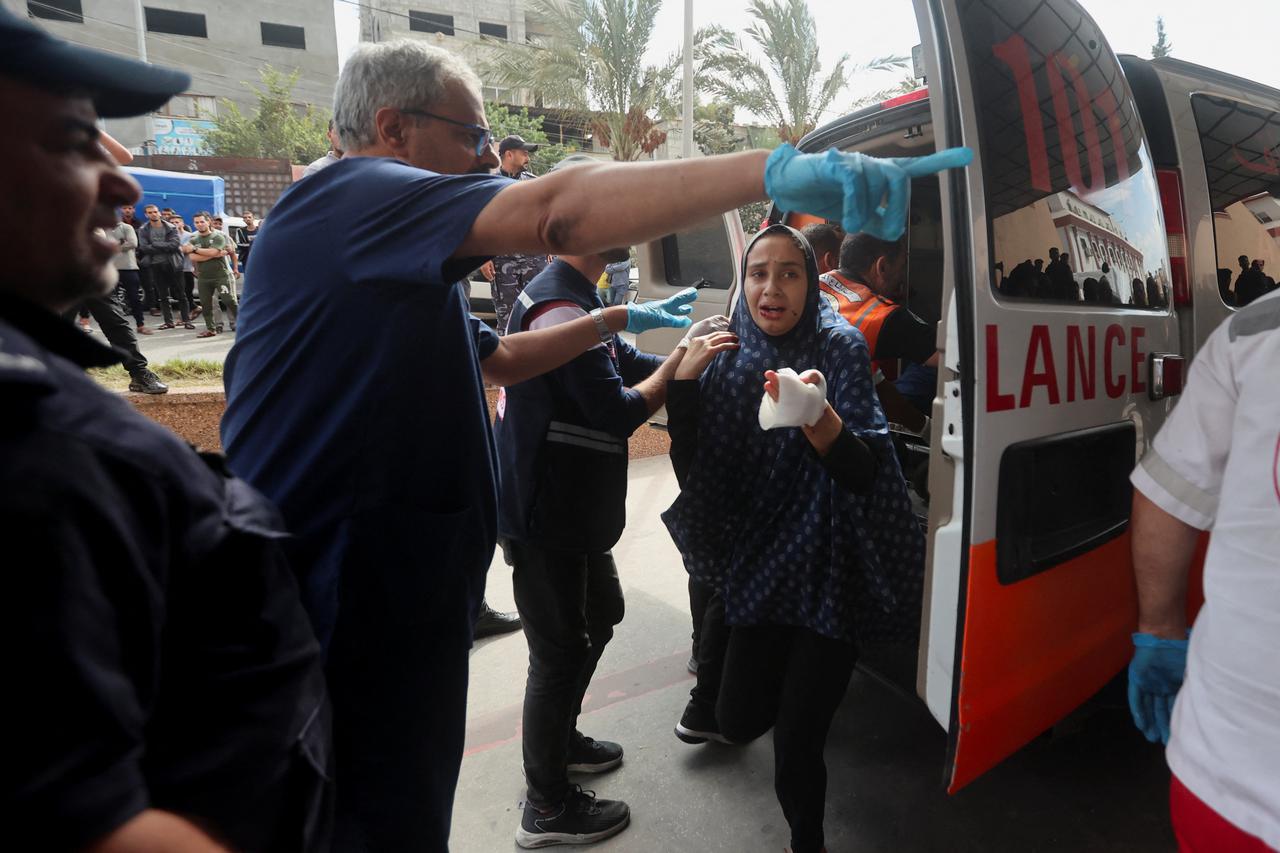 A Palestinian child, wounded in Israeli strikes lies on a bed at a hospital in Khan Younis